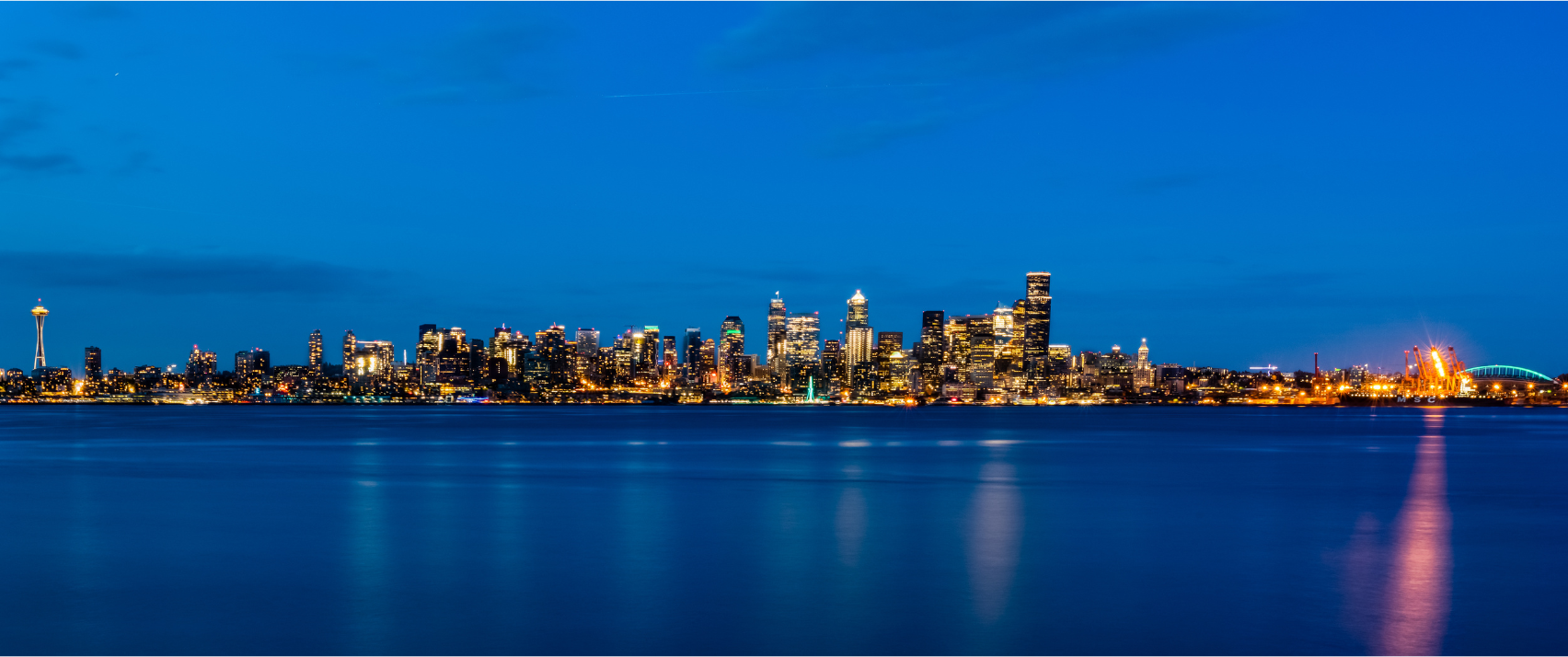 West Seattle cityscape at twilight with the Seattle skyline beyond